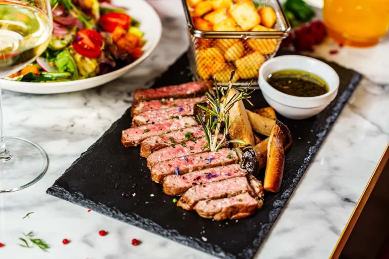 Beef steak with french fries grilled mushrooms and chimichurr